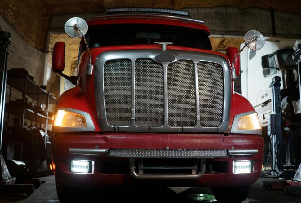 Red truck on side of road.